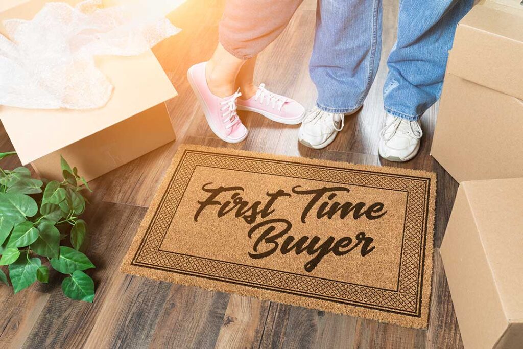 Homebuyers review a mortgage pre-approval letter and budget documents at a kitchen table.