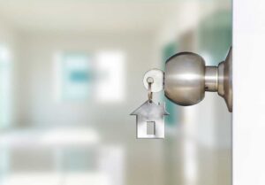 Buyer and seller review a home purchase offer with documents, calculator, and inspection notes at a table.